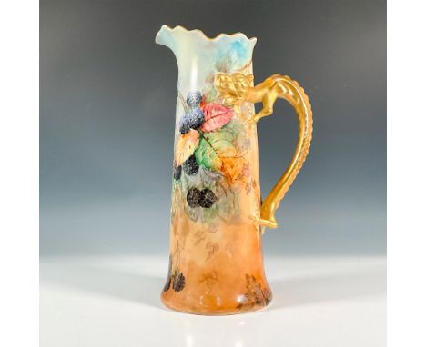 A beautiful tall pitcher with a gilded dragon handle. The jug is decorated with painted blackberries and a gilded trim. Jean 