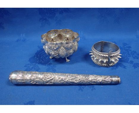 AN INDIAN REPOUSSE WHITE METAL BOWL ON DUCK FEET together with a similar decorated white metal handle and a spiked white meta