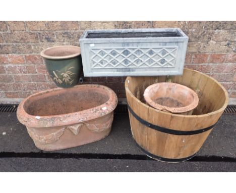 AN OVAL TERRACOTTA PLANTER 60cm wide, and other pots and planters (5 )