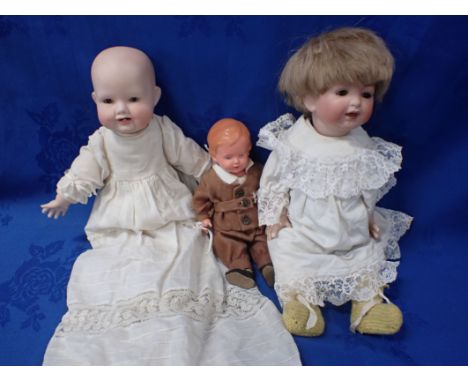 A GEORGENE AVERILL BISQUE-HEADED DOLL with cloth body and bisque limbs, with a German bisque headed doll, indistinctly marked