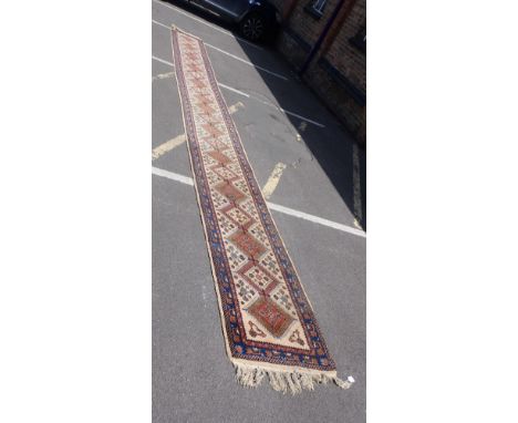 A LONG CREAM-GROUND TABRIZ RUNNER 69 x 710cm (moth damage in places)