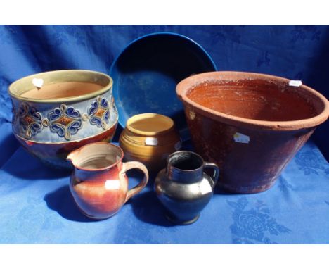 A BLACK POTTERY JUG, A ROYAL DOULTON PLANTER a country pancheon and other items