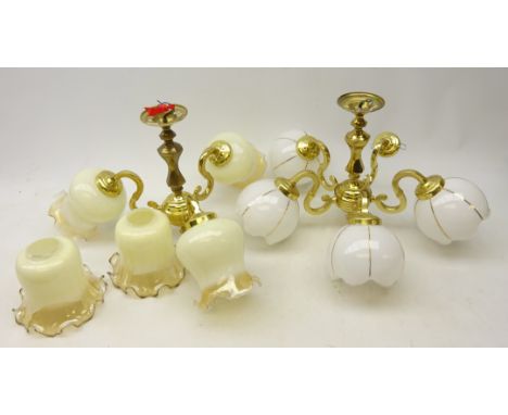 Three hanging ceiling light fittings with various shades and one wall sconce