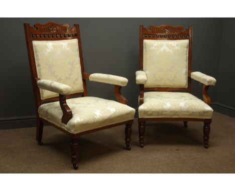 Pair Edwardian walnut framed drawing room arm chairs, carved floral cresting rail, upholstered back seat and arms in damask i