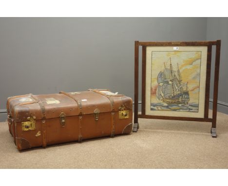 Early 20th century travelling trunk, hinged lid with clasps, (W92cm, H33cm, D57cm) and an oak fire screen with needle work de