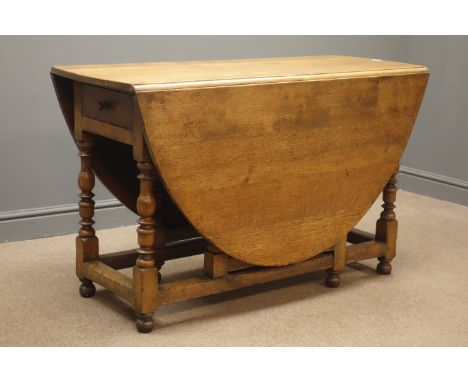 Early 20th century oak oval drop leaf gate action table, single drawer, turned supports joined by stretchers, 123cm, x 167cm,