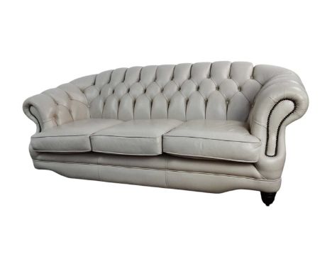 CREAM LEATHER CHESTERFIELD SOFA, AND A MATCHING CHAIR with turned legs on brass castorssofa 210cm wideQty: 2