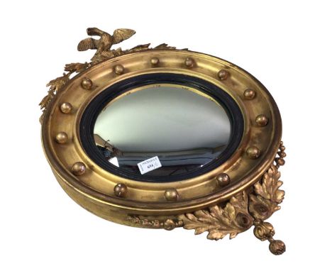 CONVEX WALL MIRROR IN A GILT FRAME, 19TH CENTURY  with eagle pediment, along with a reproduction gilt cased wall barometermir