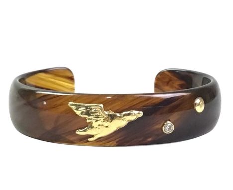 YELLOW METAL AND SIMULATED TORTOISESHELL BANGLE, the mount modelled as a duck in flight, another stamped 750, also mounted wi