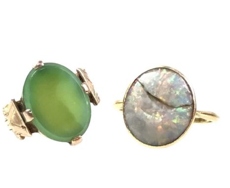 TWO GOLD DRESS RINGS, one set with an opal, in eighteen carat gold, size R 1/2, the other a green hard stone, in nine carat g