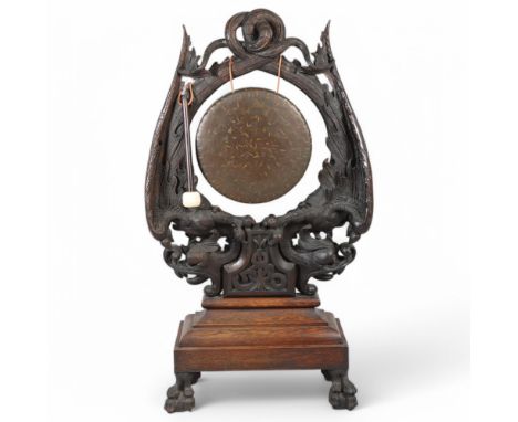 An impressive Victorian carved oak floor standing dinner gong, the frame profusely carved with inter-twined eagles and serpen