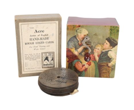 A 19th century musical box, transfer decorated hinged lid, playing 11cm discs, together with a number of spare discs and key
