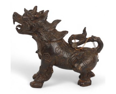 A Chinese patinated bronze temple lion, length 20cm
