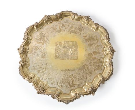 An impressive 19th century gilt metal salver. Garrard & Co.Of shaped, circular form and raised on four foliate scroll feet, t