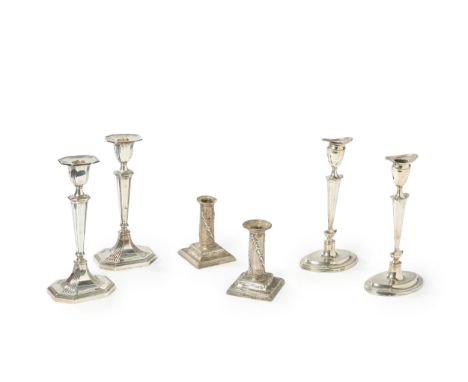 Three pairs of silver candlesticks. Various dates and makers. The group comprising: a late Victorian pair on octagonal bases,