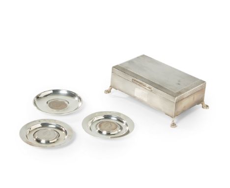 An Elizabeth II silver cigarette box. Maker J.P.,Birmingham, 1955. The rectangular, engine-turned cigarette box raised on fou