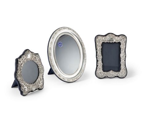 A silver mounted photo frame with foliate border.Carr's of Sheffield,London, 1987. Of oval form, with an easel back, the inne