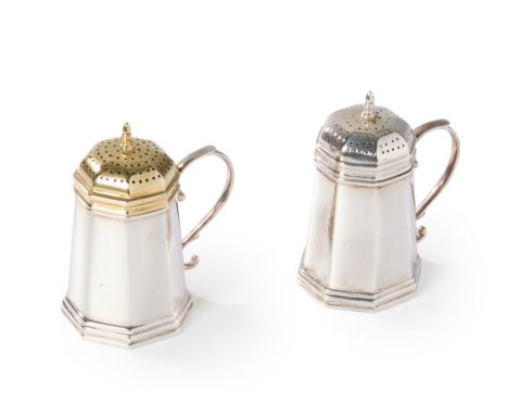 A pair of silver salt and pepper shakers.Tiffany & Co.,20th century. Of tapering, octagonal form with scroll handles and poin