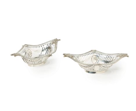 A pair of Victorian silver sweetmeat baskets.William Hutton & Sons,London, 1895.The quatrefoil-shaped baskets designed with p