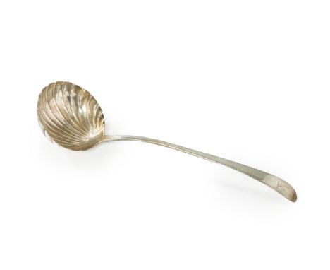 A George III Irish silver ladle.  Michael Keating, Dublin, 1779. The shell-shaped bowl to a bright-cut engraved handle, engra