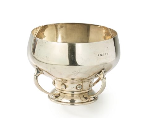 An Arts & Crafts style footed silver bowl.Edward Barnard & Sons,London, 1933.The rounded bowl to a shell-studded midsection r