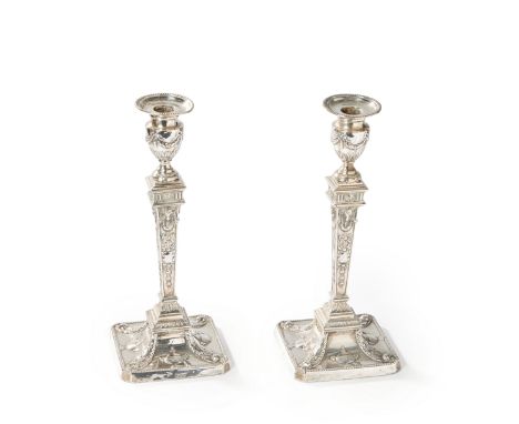A pair of late Victorian Neoclassical style candlesticks. William Hutton & Sons, London, 1897. The square bases decorated in 