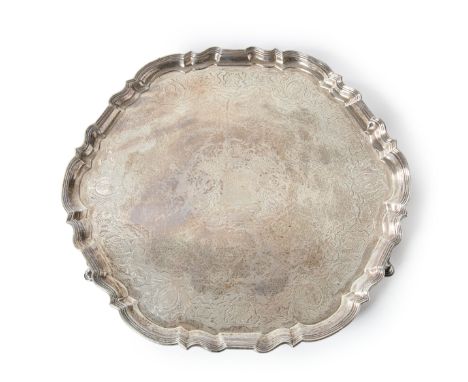 An impressive George II silver salver. Augustine Courtauld, London, 1732. The shaped, circular salver designed with a reeded 
