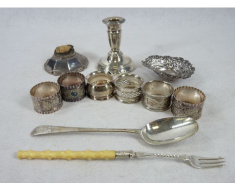 SMALL SILVER, 7 ITEMS and four white metal napkin rings, the silver items include a 20.75cms length tablespoon, marks very ru