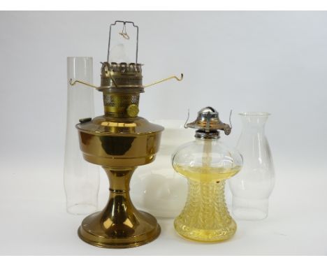 OIL LAMPS - a vintage glass based and a brass example (two chimneys, one shade)