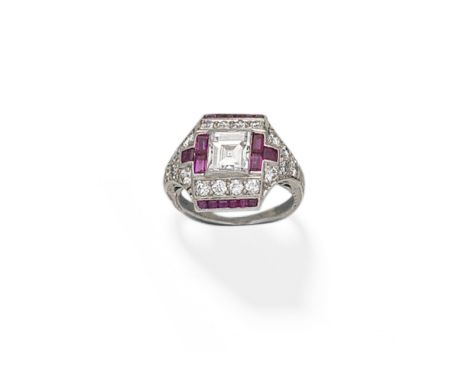 ART DECO RUBY AND DIAMOND RING, CIRCA 1925Of plaque design, set with a central step-cut diamond, within a calibré-cut ruby an