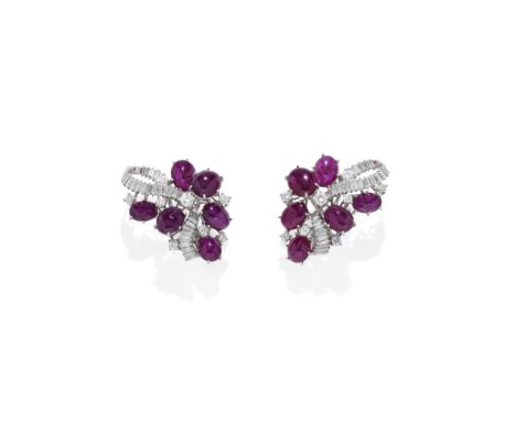 RUBY AND DIAMOND EARCLIPS, CIRCA 1960Each baguette-cut diamond ribbon accented by oval ruby cabochons and brilliant-cut diamo