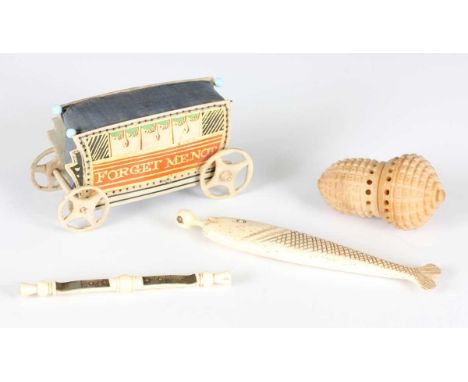 A 19th century bone novelty pin case in the form of a fish, the removable lid inset with a Stanhope lens displaying views of 