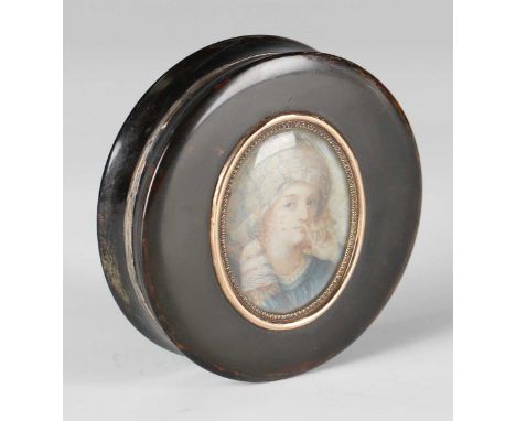 An early 19th century pressed tortoiseshell circular snuff box, the lid inset with a glazed portrait miniature, the interior 