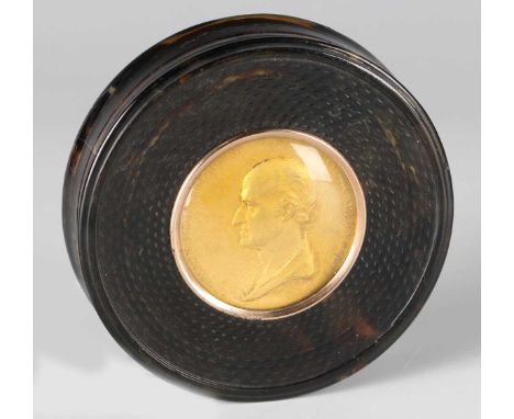 A George III tortoiseshell circular snuff box, the lid inset with a glazed gilt metal portrait medallion of 'Benjamin West, P