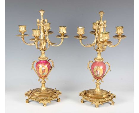 A pair of late 19th century gilt metal and porcelain four-light candelabra, height 42cm (faults and restoration).