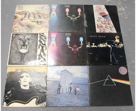 A collection of thirty-three LP records, including albums by Paul McCartney, George Harrison, The Moody Blues, Roxy Music and