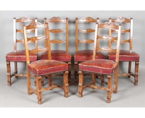 A set of six early 20th century French oak framed ladder back dining chairs with brass-studded claret leather seats, height 1