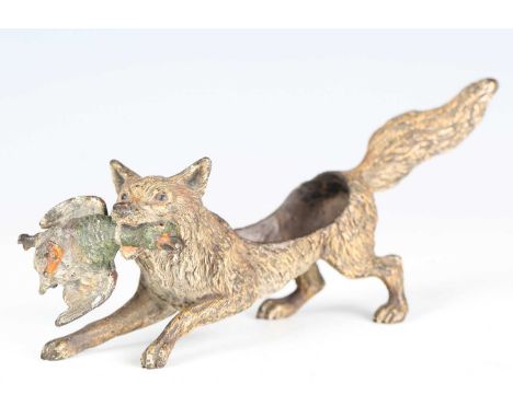 A late 19th century Viennese cold painted cast bronze pin cushion model of a fox holding a duck in its jaws, bearing 'Geschut