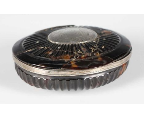 A late George III tortoiseshell and white metal mounted oval table snuff box, the lid and base with reeded panels, the centra