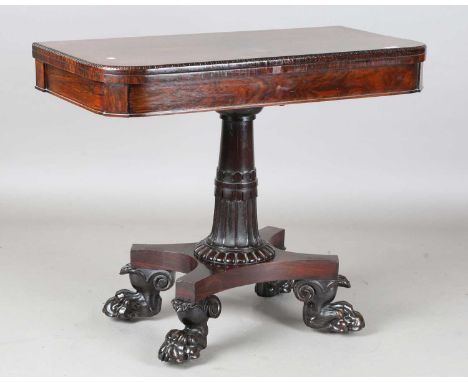 A Regency rosewood fold-over card table, the quatrefoil platform with carved claw feet, height 75cm, width 91cm, depth 46cm.