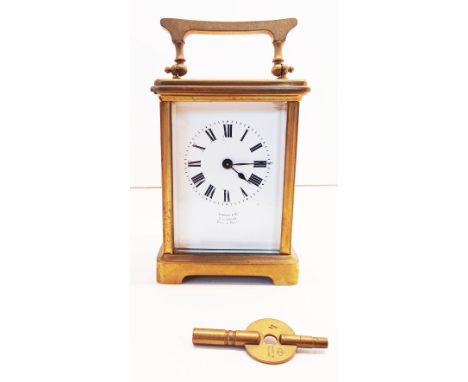 A BRASS TRAVEL CARRIAGE CLOCK WITH KEY