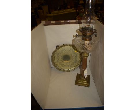A Victorian table oil lamp with clear cut glass reservoir, standing on a brass corinthian column square base; together with a