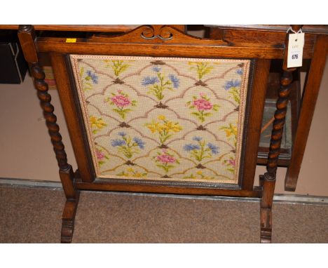 An early 20th Century oak framed needlework firescreen.