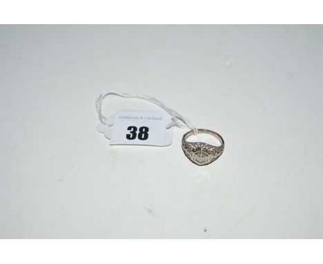 A diamond set openwork ring, the brilliant cut diamond in hexagonal mount with scrolling shoulders, ring size K.
