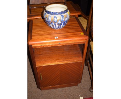 A pair of modern mahogany bedside cabinets, with rounded corners and pull-out slides above an open shelf, fitted a cupboard i