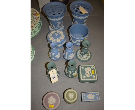 A quantity of Wedgwood Jasperware in blue, green and pink, to include: three pairs of vases; circular pot and cover; candlest