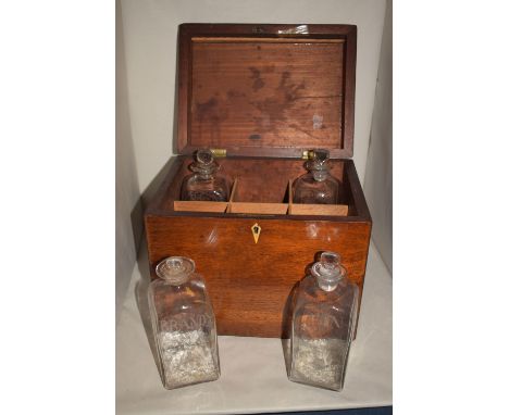 A 19th Century mahogany decanter box, with boxwood stringing, fitted four decanter bottles with 'Rum', 'Gin', 'Gin' and 'Bran