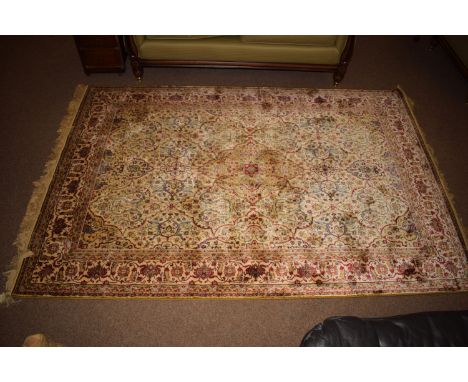 A cashmere carpet, the Persian style scrolling design on ivory ground.