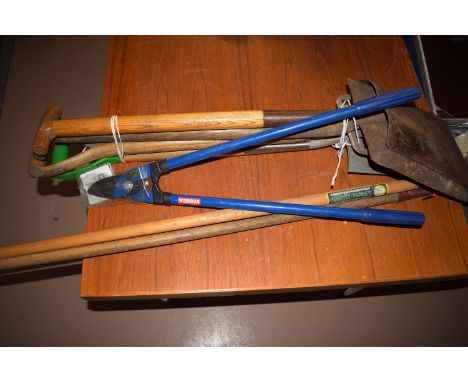 A bundle of garden tools; and a pair of long handled pruning loppers.