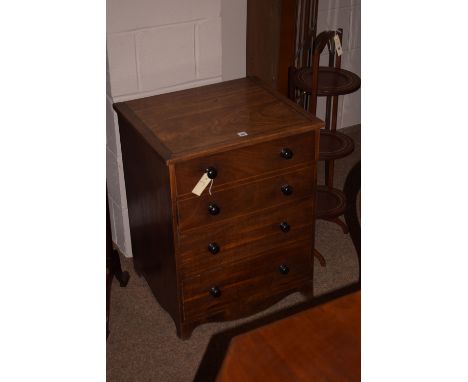A George III mahogany commode, the hinged top revealing commode cut-out above false drawers.